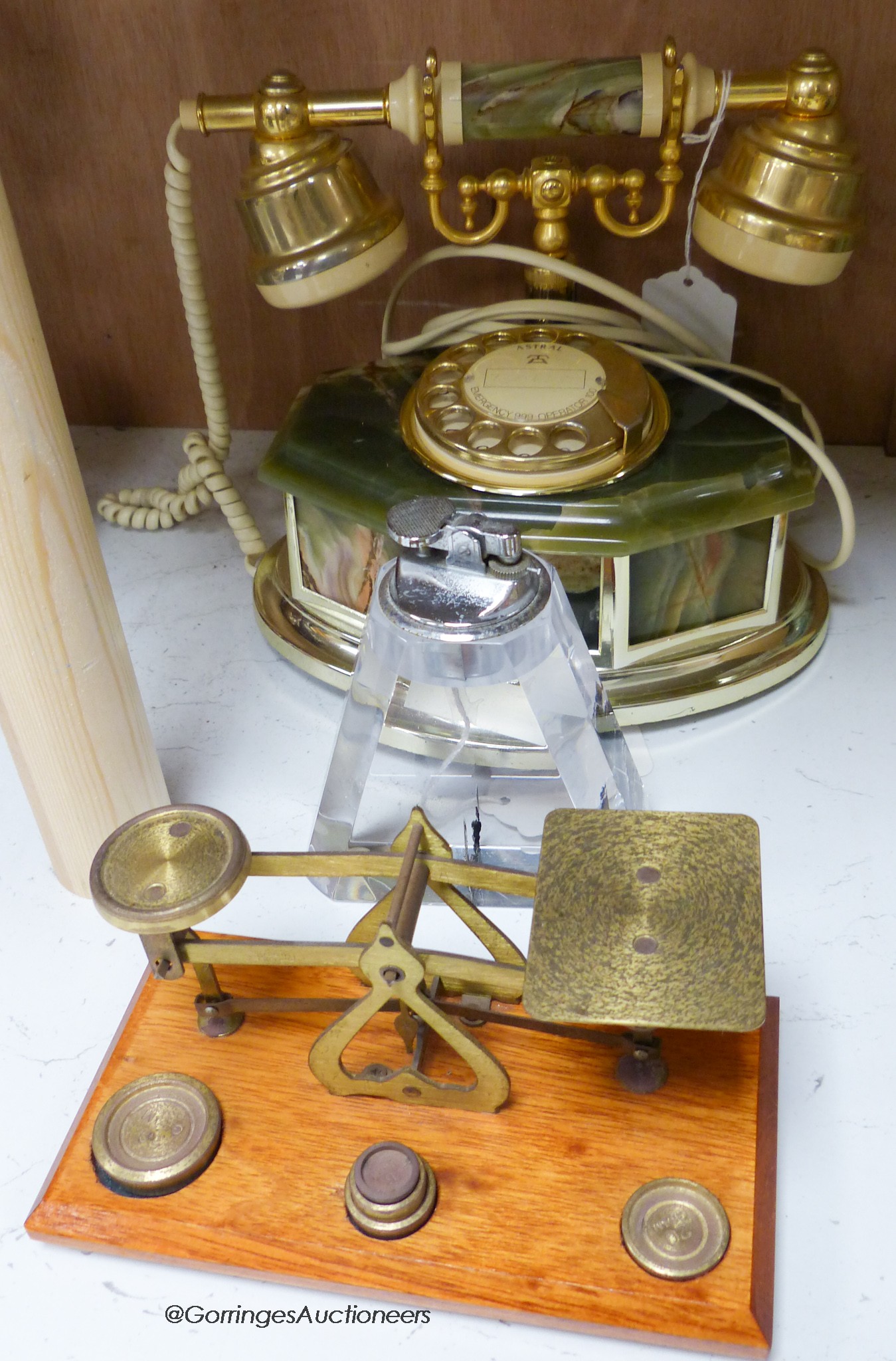 A pair of brass letter scales, a 1960's plastic table top lighter and an onyx telephone